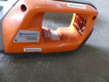 an orange and black blower sitting on the floor