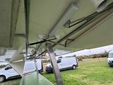 a plane that is parked on the grass in the field
