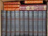 many books in a box on the shelf