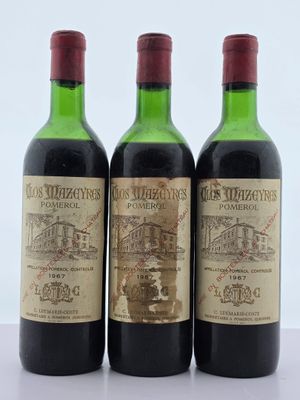 trois bouteilles de vin posées sur une table l'une à côté de l'autre