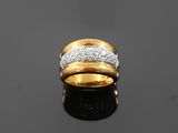 a close up of a gold and diamond ring on a black surface