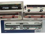 four model buses are stacked on top of each other in boxes