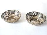 pair of silver plated bowls on a white background