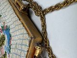 a purse with a chain hanging from it on a wall