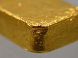 a piece of gold on a white surface