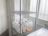 an image of a kitchen with a sink and a shelf