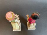 two figurines of mice with hats on them