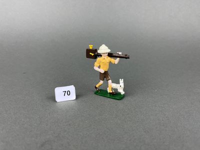 toy figurine of a man with a rifle and a dog on a board
