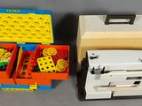 two boxes of legos and a sewing machine on the table