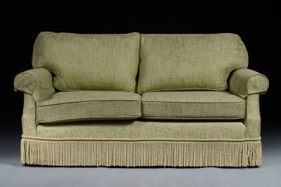 a green couch with a ruffled skirt on it