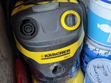 a yellow and black vacuum sitting next to buckets of paint
