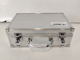 a silver suitcase sitting on a white surface