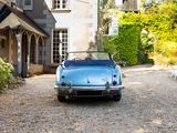 a blue car that is parked in front of a house