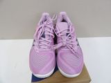 purple nike shoes on a box on a white surface
