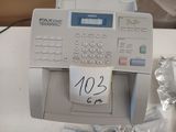 a picture of a fax machine with a note taped to the front of it