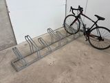 a bike that is parked next to a bike rack