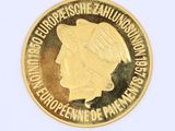 the coin is gold and has a picture of a woman ' s face