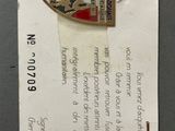 a picture of a badge that is on top of a piece of paper