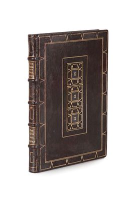 an old book with a decorative design on the cover