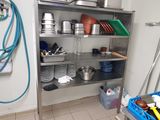 une étagère métallique avec des casseroles et des poêles dans une cuisine