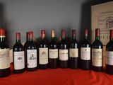 several bottles of wine are lined up on a table