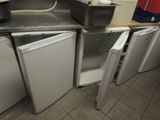 a kitchen with a sink, refrigerator, and freezer in it