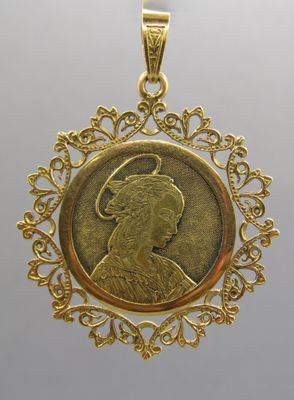 a gold pendant with a portrait of a woman in profile