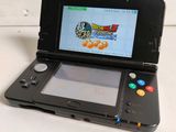 a black nintendo 3ds with a game on the screen