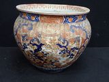 a large vase that is sitting on a black surface