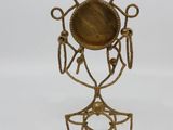 an image of a brass candle holder on a white background