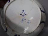 a white bowl with a blue design on it