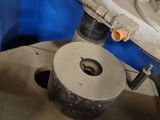 an image of a machine that is working on a piece of metal