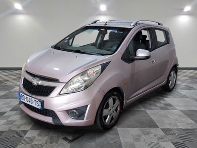 a picture of a small pink car parked in a garage