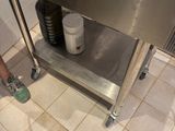 a person standing in a kitchen with a sink and stove