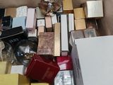 a cardboard box filled with various types of perfumes