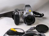 a silver camera with a cord attached to it