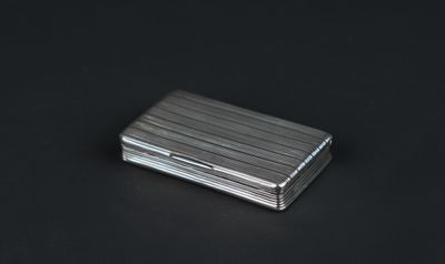 an image of a silver cigarette case sitting on a black surface
