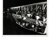 black and white photograph of a boat with people on it at night
