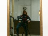 a woman taking a picture of herself in a mirror
