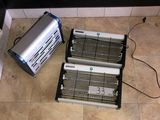 two electric heaters sitting on the floor next to each other