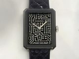 a black watch with a pattern on the face of it
