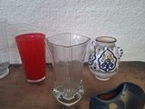 many different vases sitting on a wooden table
