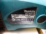 a close up of a blue corded drill on a table