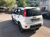 a small white car parked on the side of the road