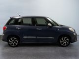 the small blue car is parked on the concrete floor in the room