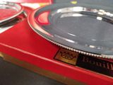 a silver plate sitting on top of a red box