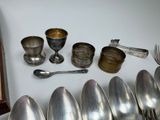 many spoons and silverware sitting on a table