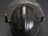 a close up of a metal helmet with a clear vise on it