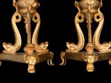 two golden vases on a black background with a black background