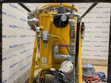 a yellow machine that is sitting next to a wall